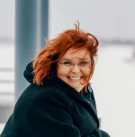 Mari Alila, Property Manager at Alila Oy, smiles for the camera.